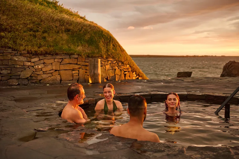 Bathers in the Sky Lagoon at golden hour near Reykjavik